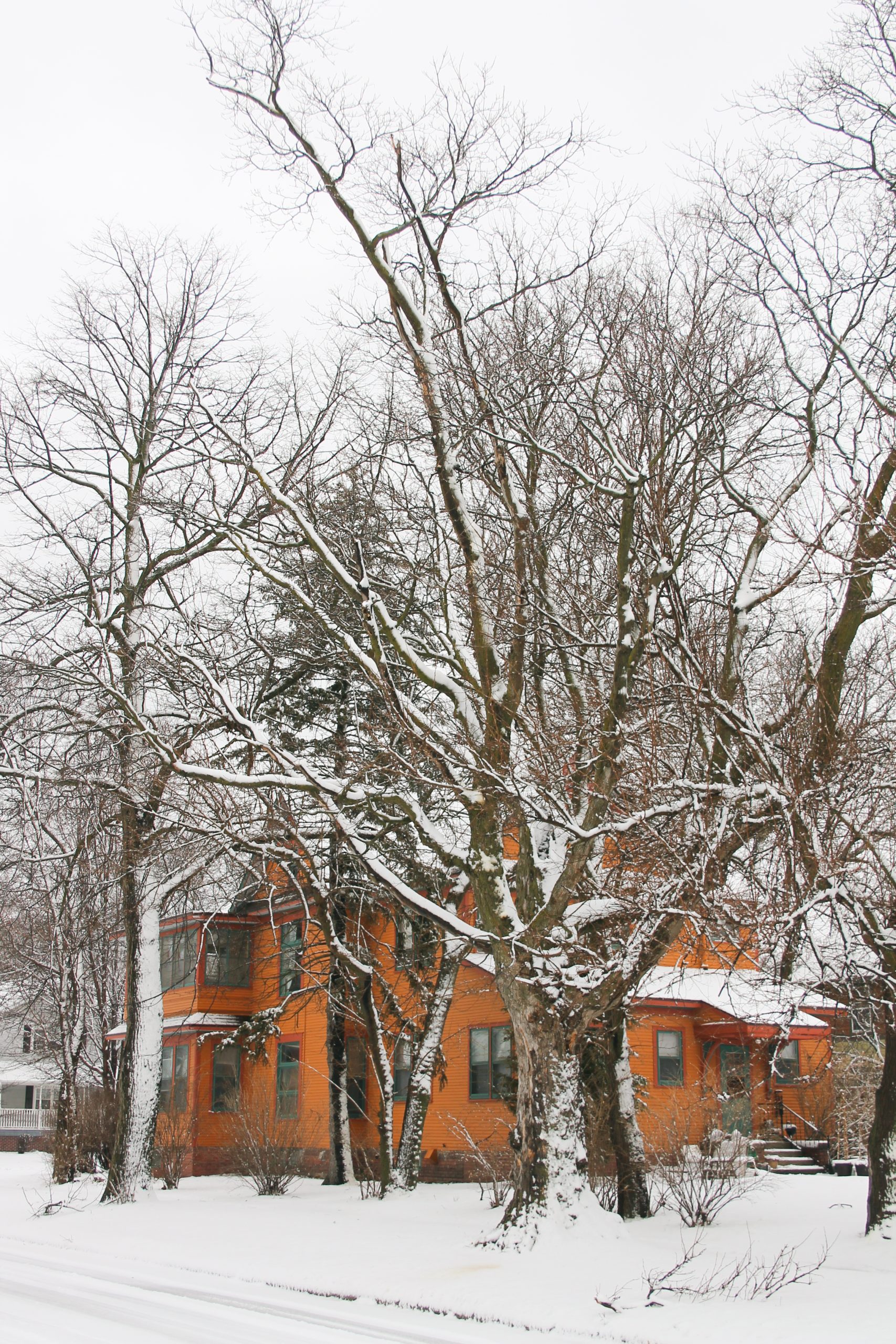 orange house covered in snow